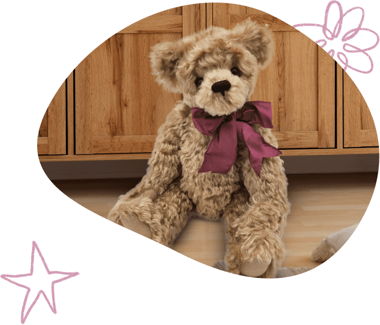 teddy bear with burgundy bow